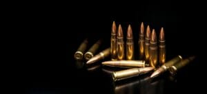 Bullet isolated on black background with reflexion. Rifle bullets close-up on black back. Cartridges for rifle and carbine on a black.